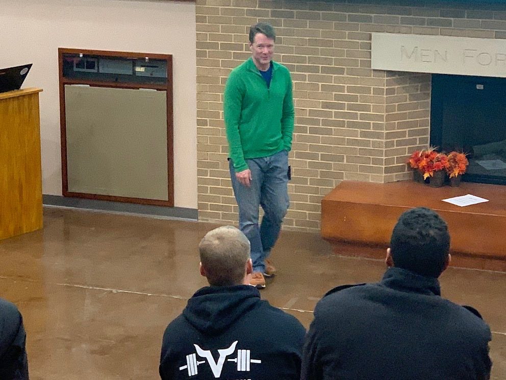 Chris Korfist presenting to a room at a coaching conference